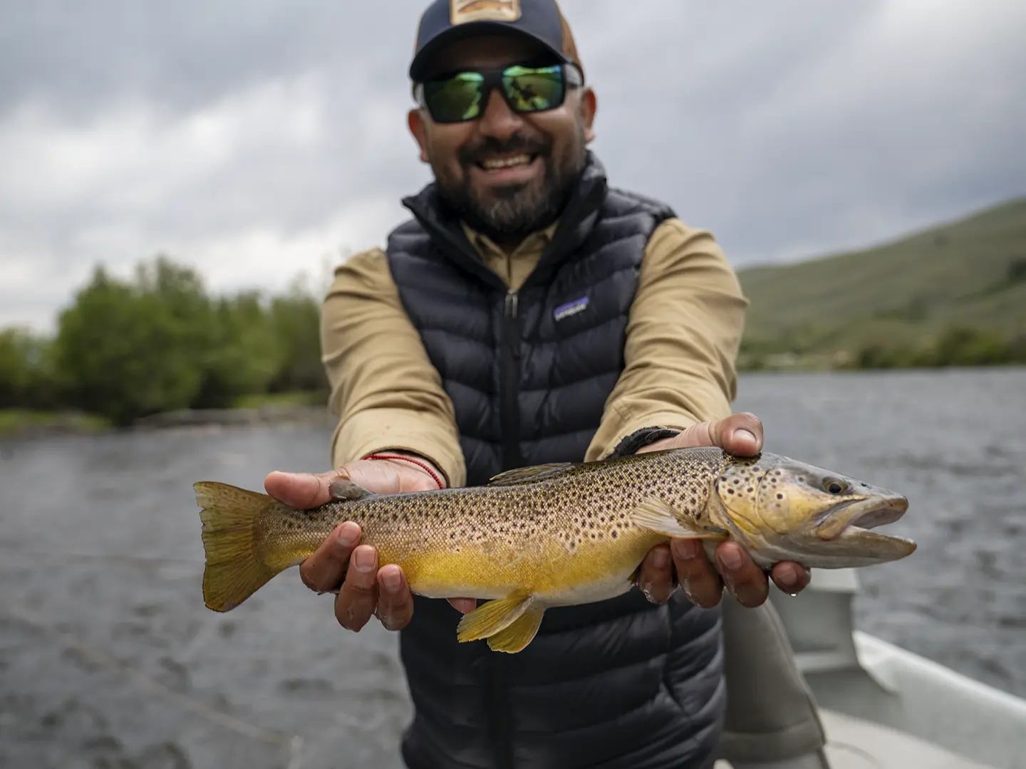 Chile Fly Fishing guide holding a wild brown trout on Montana's Madison River