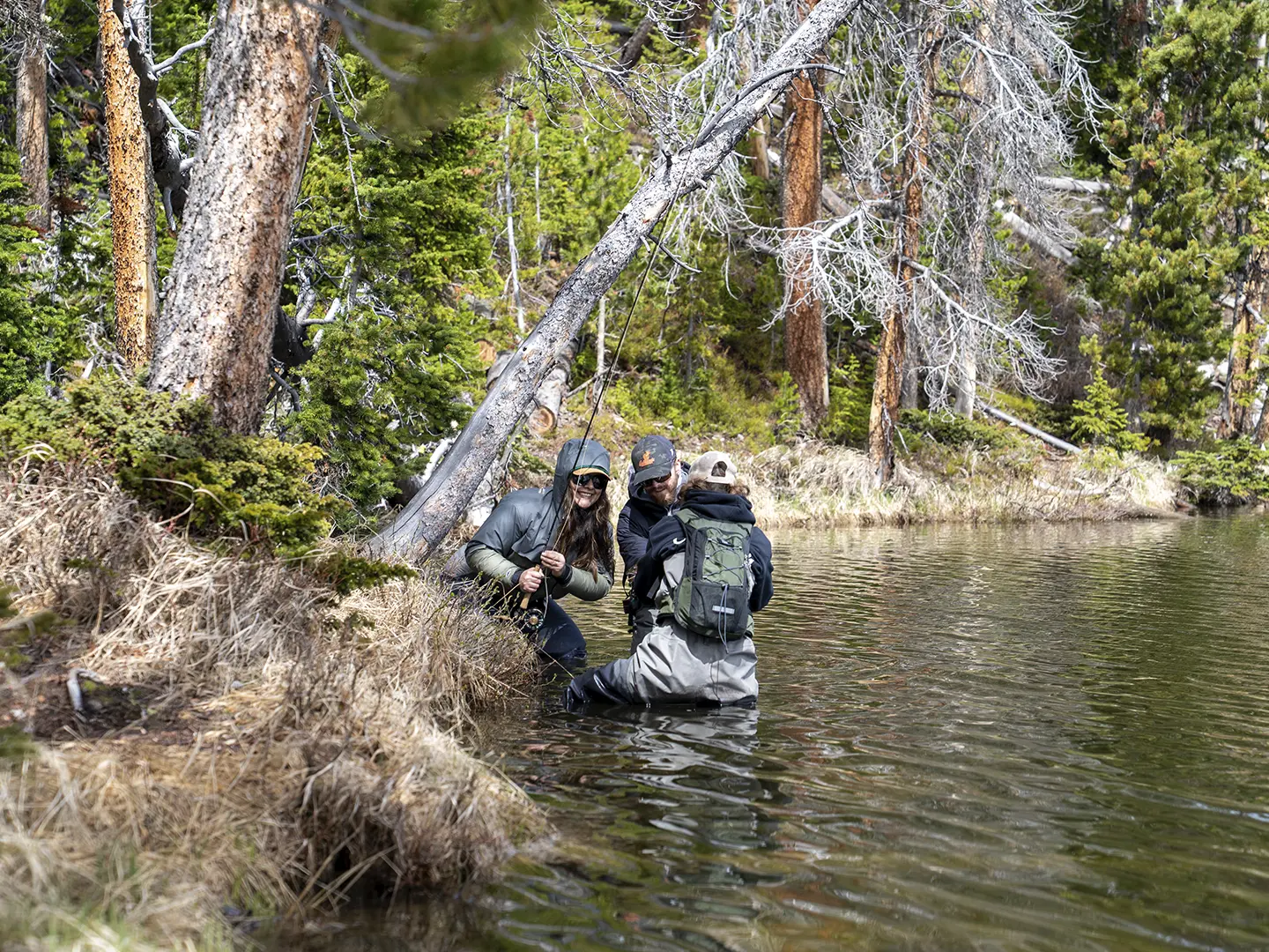Anglers wading a backcountry alpine lake near Dubois, Wyoming